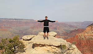 Un touriste heureux à un point de vue du Grand Canyon sud.
